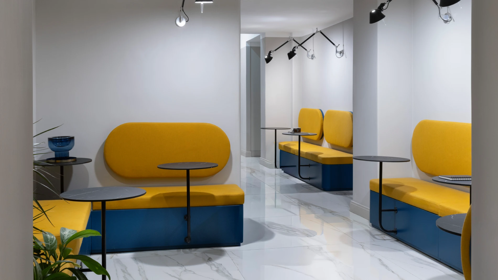 Lounge area with yellow upholstered seating and tables in hotel corridor - Hotel XX Settembre, BZAR hotels in Rome